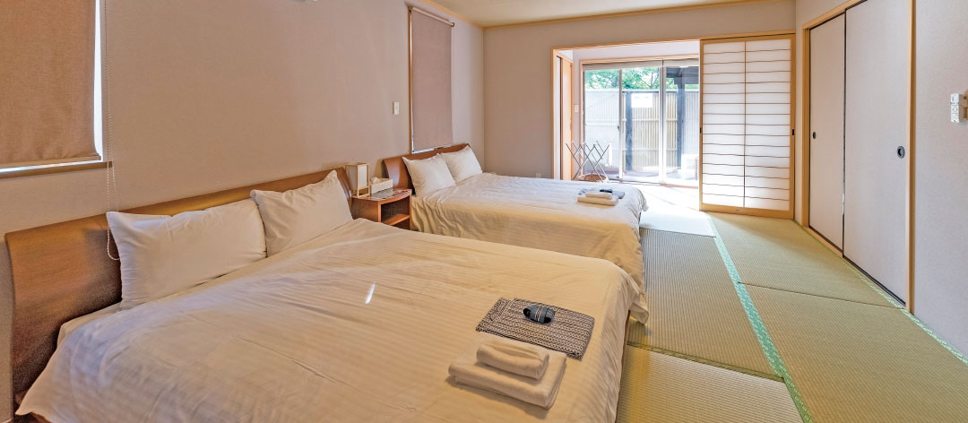 Japanese room with bed(s) & open-air hot spring